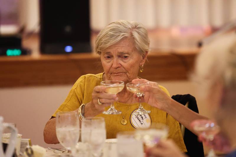 Lori Spesia, of the Women of Rotary, partakes in a toast at a luncheon to celebrate the 110th anniversary of the Rotary Club at Jacob Henry Mansion on Tuesday, Aug. 1 in Joliet.