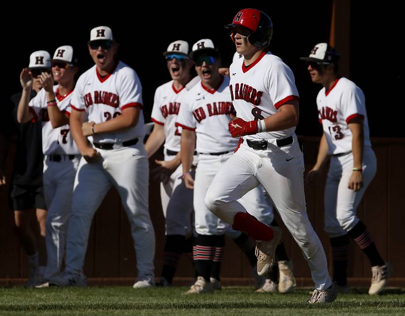 Huntley’s Brayden Bakes is cheered on by his teammates as he runs the bases after hitting a home run during a IHSA Class 4A baseball sectional semi-final baseball game between Jacobs and Huntley at Jacobs High School in Algonquin.
