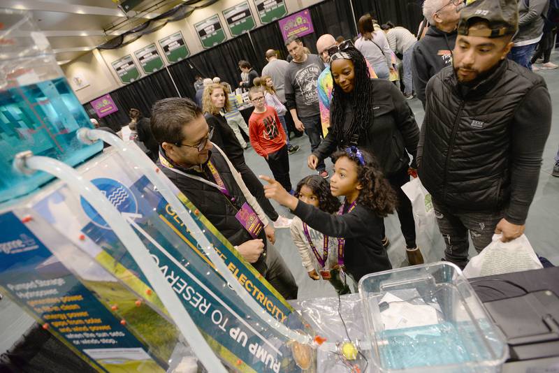 Children including (left) Elijah and Xavier Vega of Naperville get a lesson on Hydro Power studies with the help of Argonne employee Carlos Lopez during the STEMCON event on Saturday April 26, 2025 at the College of DuPage in Glen Ellyn.