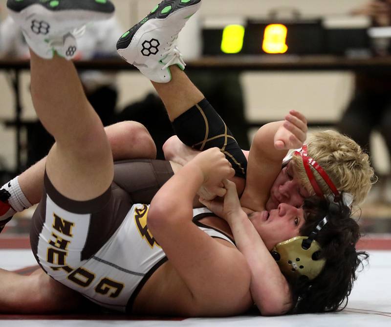 Huntley’s Radic Dvorak tries to pin Jacobs’ Jesus Reyes during the 175—pound match of a Fox Valley Conference wrestling meet on Thursday, Dec. 11, 2025, at Huntley High School.