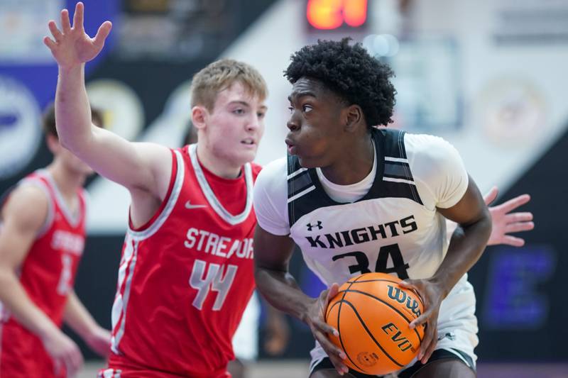 Kaneland’s Jeffrey Hassan (34) plays the ball in the post against Streator's Nolan Lukach (44) during a semi-final basketball game in the 61st annual Plano Christmas Classic at Plano High School on Friday, December 27, 2024.