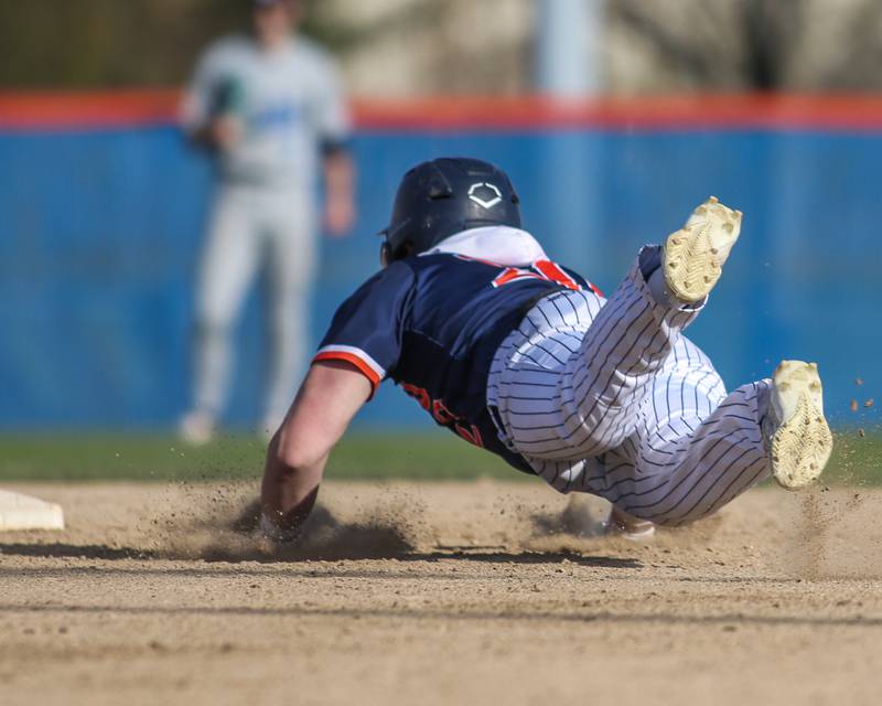 Oswego's Dylan King (20) slides into second during baseball game between Plainfield South at Oswego on Monday, April 14, 2025 in Oswego.