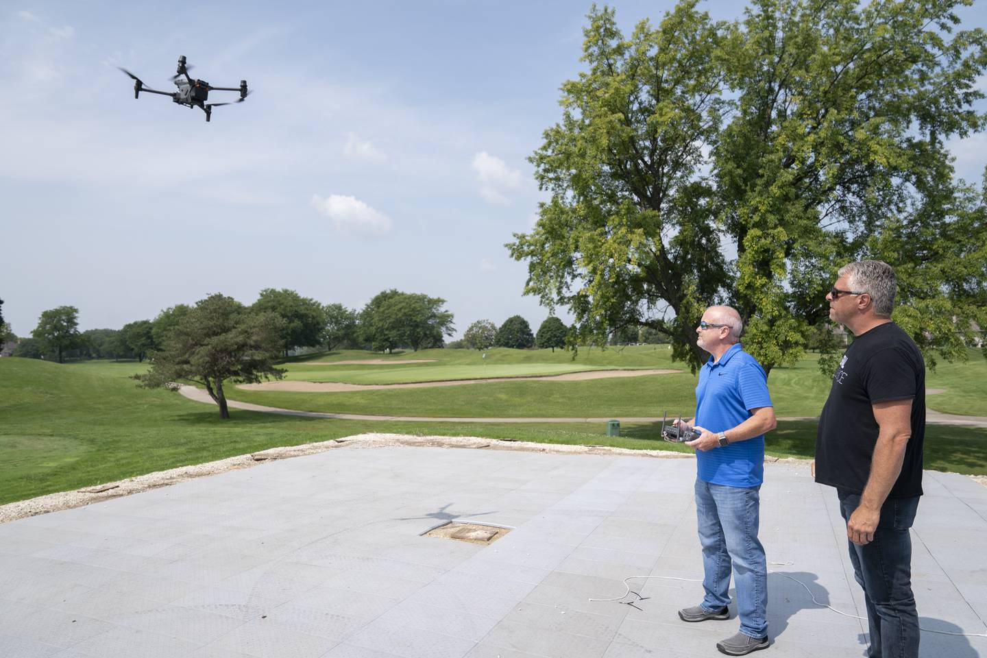 Village of Lakewood Police Sgt. Sean McGrath, left, receives training on the police department's new DJI Matrice M30T drone by Michael Ferguson of Aerial Influence on Friday, Aug. 18, 2023, at RedTail Golf Club in Lakewood.