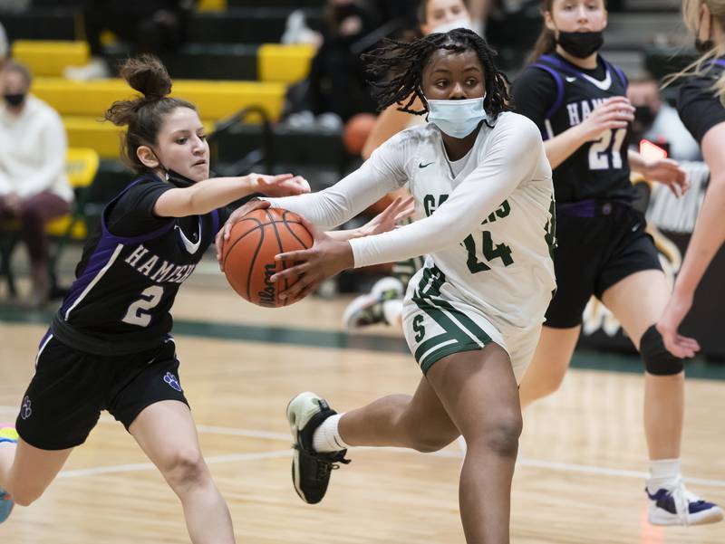 Hampshire's Alex Montez gets a hand on the ball as Crystal Lake South's Kree Nunnally drives to the basket during their game on Friday, January 14, 2022 at Crystal Lake South High School.
