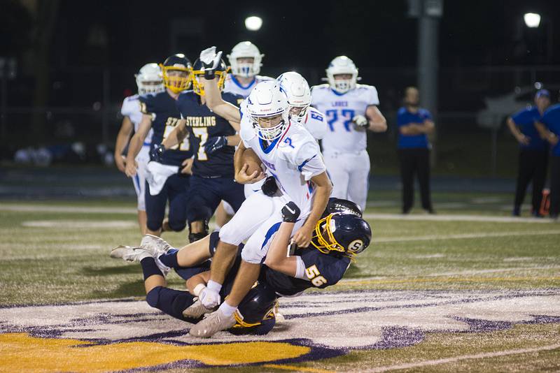 Sterling’s Lucas Austin hauls down Lakes’ Max Bausch Friday, Aug. 26, 2022.