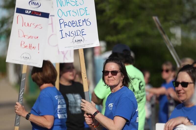 Chris McCafferty, a nurse for 21 years, holds a picket sign outside Ascension Saint Joseph-Joliet hospital as a whole year approaches since contract negotiations started on Wednesday, May 1, 2024 in Joliet.