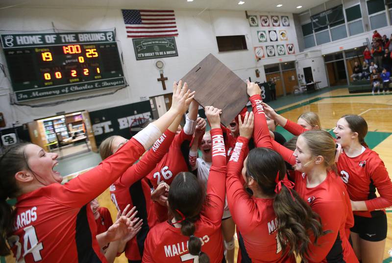 Members of the Henry-Senachwine volleyball team hoist the Class 1A Regional plaque after defeating St. Bede on Thursday, Oct. 31, 2024 at St. Bede Academy.