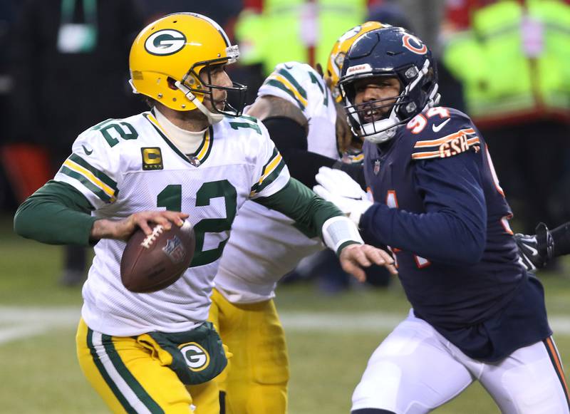 Chicago Bears linebacker Robert Quinn (94) can't get to Green Bay Packers quarterback Aaron Rodgers (12) before he throws a touchdown pass during their game Sunday at Soldier Field in Chicago.