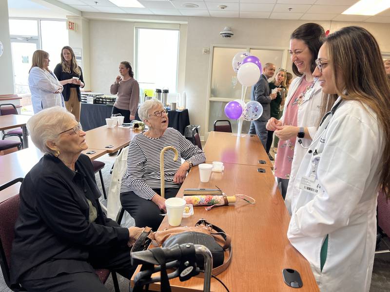 Former patients Susan White and Phyllis Glover catch up with Valley West patient care manager Ashley Brown and Dr. Sarina G. Jeswani, hospital medicine physician, at the five-year celebration for Northwestern Medicine Valley West Hospital’s Homeward Healing program.