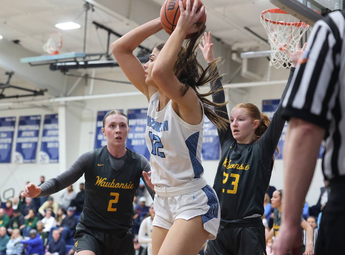 Nazareth’s Jane Manecke (12) looks to pass the ball against Waubonsie Valley during a girls varsity basketball game on Thursday, Feb. 8, 2024 in La Grange Park, IL.