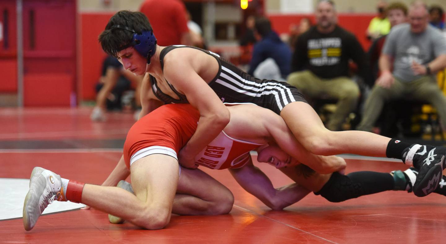 Hinsdale Central’s Cody Tavoso, left, wrestles Joliet Catholic’s Luke Hamiti during the in the 145-pound finals match of the Hinsdale Central wrestling invite in Hinsdale Saturday.