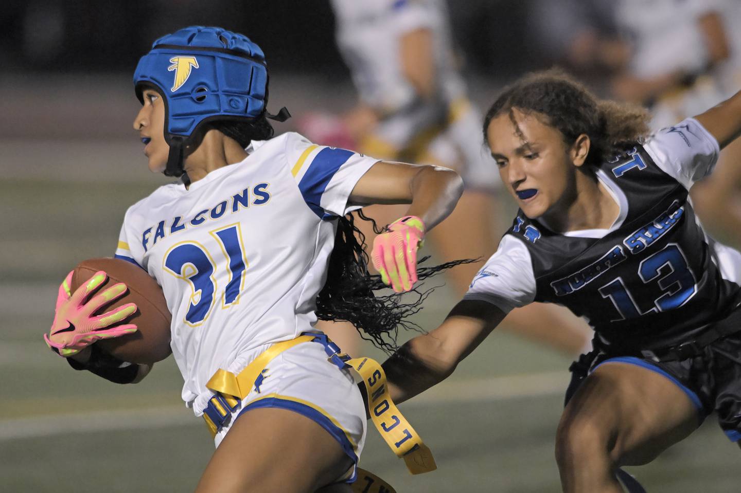 Wheaton North’s Brea Moore tries to get past St. Charles North’s Alexandria Richardson in a girls flag football game in St. Charles on Monday, Sept. 15, 2025.
