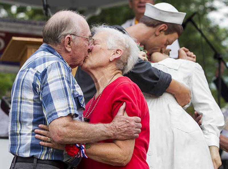Bill and Doris Schabow of McHenry kiss in front of the crowd Sunday at Veterans Memorial Park in McHenry during the fourth annual Keep the Spirit of '45 Alive day. The Schabows married in 1951. Congress has designated the second Sunday of August as a national day of remembrance honoring all members of “The Greatest Generation” and the end of World War II. This year's celebration will honor veteran and nonveteran couples married in and before 1953.