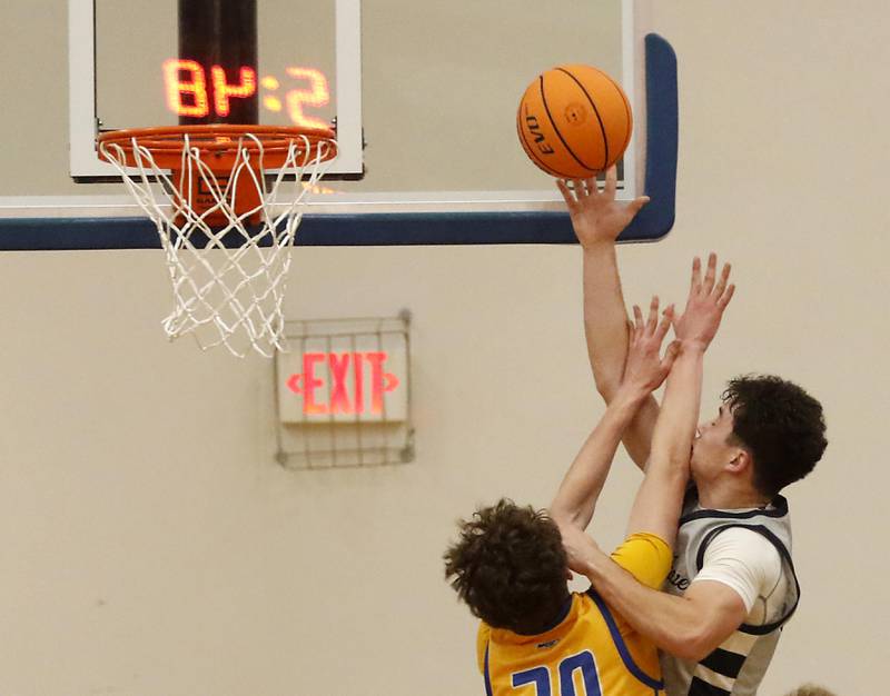 Johnsburg's Josh Kaunas fouls Cary-Grove's Brady Bauer as he drives to the basket during a Johnsburg Thanksgiving Tournament boys basketball game on Monday, Nov. 24, 2025, at Johnsburg High School.