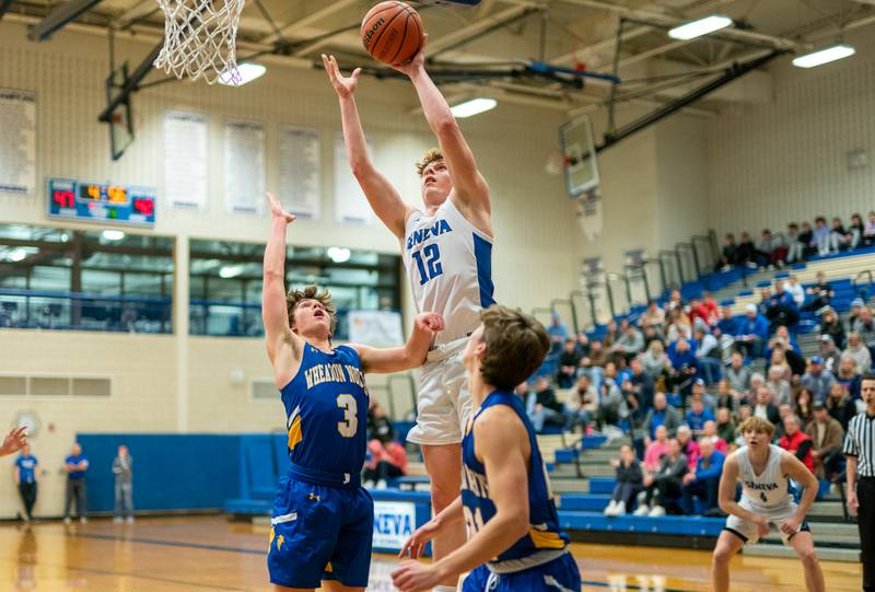 Geneva’s Thomas Diamond (12) shoots the ball in the post over Wheaton North's Jack Speers (3) and Connor Speers (21) during a basketball game at Geneva High School on Friday, Jan 6, 2023.