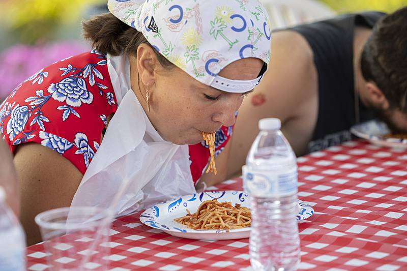 Julia Thornton digs into a plate of spaghetti Saturday, Aug. 10, 2024 during an eating contest at Dixon’s Venetian Night. Contestants won by speed, with Thornton bowing out pretty quickly.