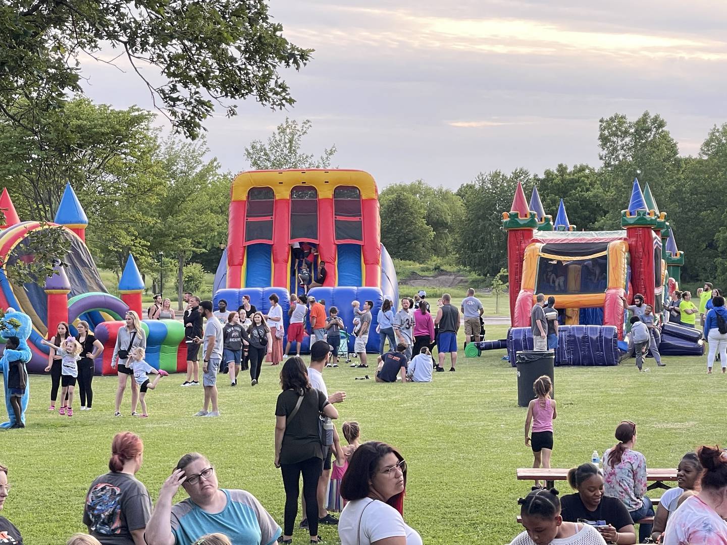 Families explore inflatables at a previous Bourbonnais Township Park District Family Night Out at Perry Farm Park.