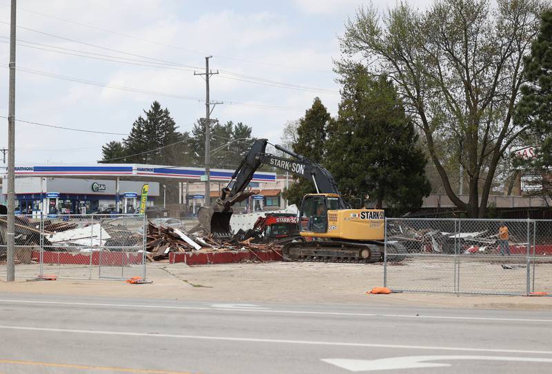 Debris is cleared Monday, April 28, 2025, at the site of the former Illini Tire Co. building on the northeast corner West Lincoln Highway and Annie Glidden Road.