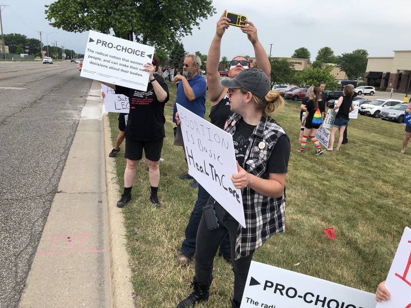 Protesters gathered Monday, July 4, 2022, on Route 14 in Crystal Lake to rally against the decision overturning Roe v. Wade in late June.