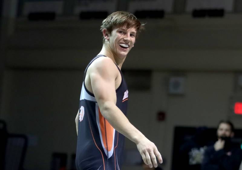 McHenry’s Chris Moore grins after a win over Crystal Lake South’s Erik Gonzalez in 160-pound action during varsity wrestling at Crystal Lake Thursday night.