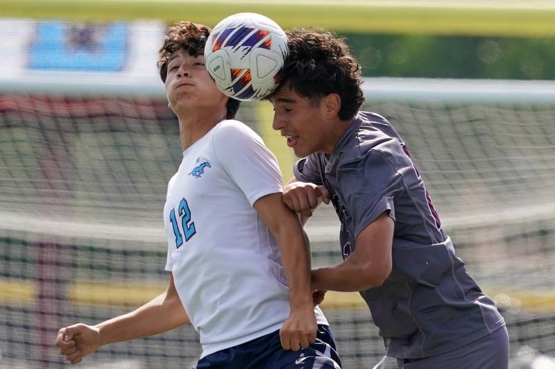 Morton’s Dario D Cisneros (22) heads the ball against Downers Grove South's Daniel Smazil (12) during a soccer match at Morton High School in Berwyn on Saturday, Oct. 5, 2024.