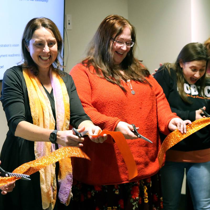 Jessica Marcellis-Montavon, (left) DeKalb School District 428 Transition Program teacher and vocational coordinator, along with other teachers in the program cut the ribbon Wednesday, Jan. 22, 2025, during the grand opening celebration of the Beyond One Barb Transition Center in DeKalb. The the transition program has been in place to facilitate students with intellectual and developmental disabilities aged 18-22 into adulthood and independent living.