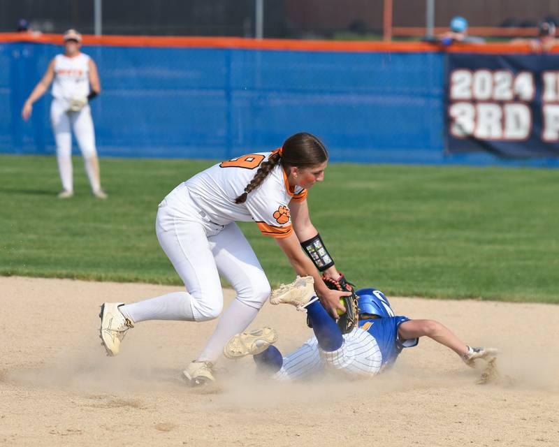 Wheaton Warrenville South's Kelsey Clousing (9) tries to put the tag on  Wheaton North's base stealer Reagan Crosthwaite (21) but wasn’t in time during the sectional semifinals on Thursday June 5, 2025, held at Oswego High School.