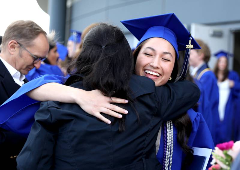St. Charles North graduate Heidi Rey hugs her loved ones following the school’s 2025 commencement ceremony on Thursday, May 22, 2025 at Northern Illinois University in DeKalb.