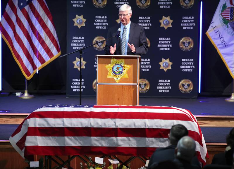Retired DeKalb County Chief Deputy Kevin Hickey speaks over the casket of former DeKalb County Sheriff Roger Scott during his memorial service Friday, March 7, 2025, at Bethany Road Bible Church in DeKalb. Scott, who was the county sheriff for 36 years, died on February 23 at the age of 78.
