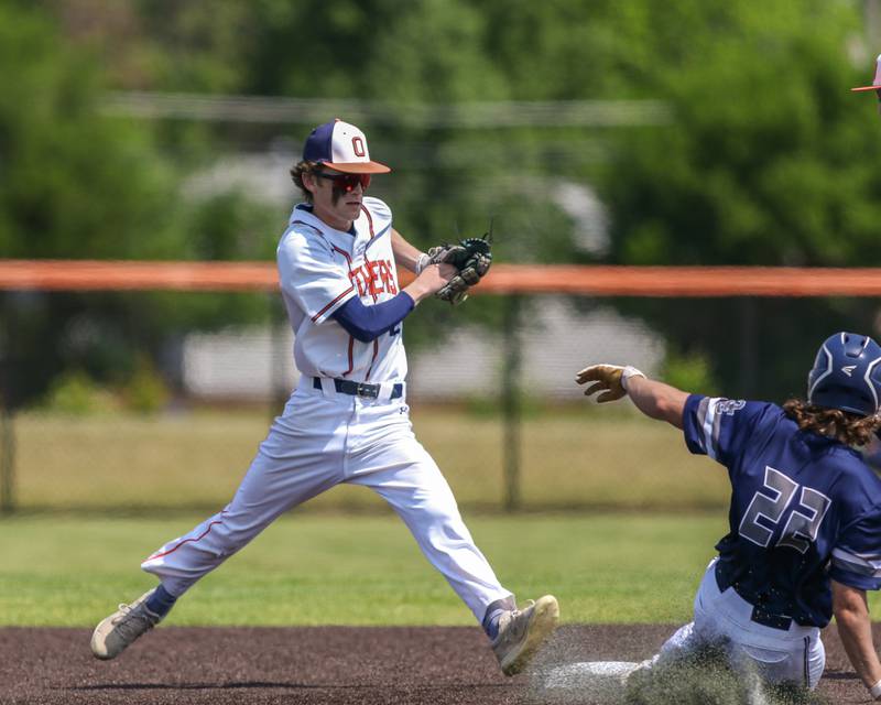 Oswego's Chase Gerwig (2) steps to the second base bag to record the out during Class 4A Romeoville Sectional final game between Oswego East at Oswego.  June 3, 2023.