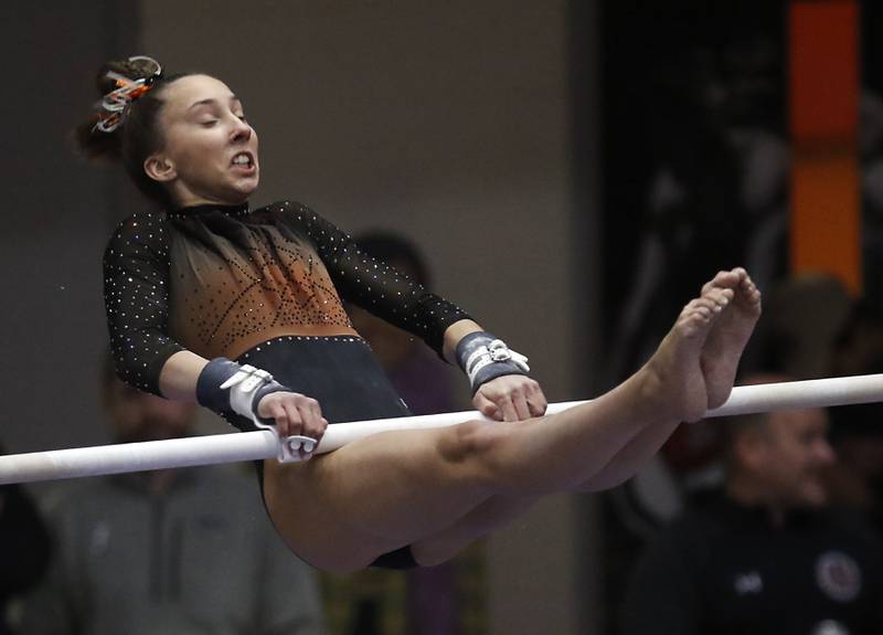 Libertyville’s Anna Baker competes in the of the uneven parallel bars Friday, Feb. 17, 2023, during the IHSA Girls State Final Gymnastics Meet at Palatine High School.