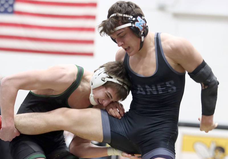Marian’s Nic Astacio, right, battles Crystal Lake South’s Aiden Marrello at 165 pounds in boys wrestling IHSA Class 2A Regional championship bout action on Saturday, Jan. 31, 2026, at Harvard High School in Harvard.