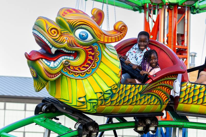 Joliet residents Kunashe and Alianna Muzvi ride the rollercoaster during Taste of Joliet on June 20, 2025.