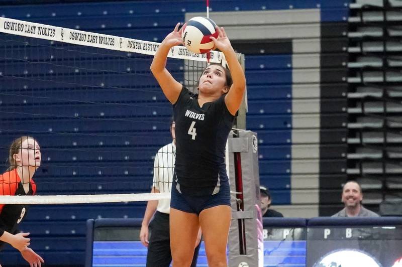 Oswego East's Riley Trefny (4) sets the ball during a Southwest Prairie Conference match against Minooka in Oswego on Thursday, Sept. 18, 2025.