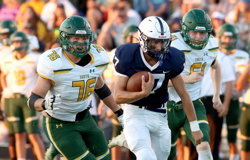 Crystal Lake South’s Nathan Compere, left, and Dom Ariola, right, pursue Cary-Grove’s Gavin Henriques, center, as Henriques runs in a first-quarter touchdown at Al Bohrer Field on the campus of Cary-Grove High School Friday night.