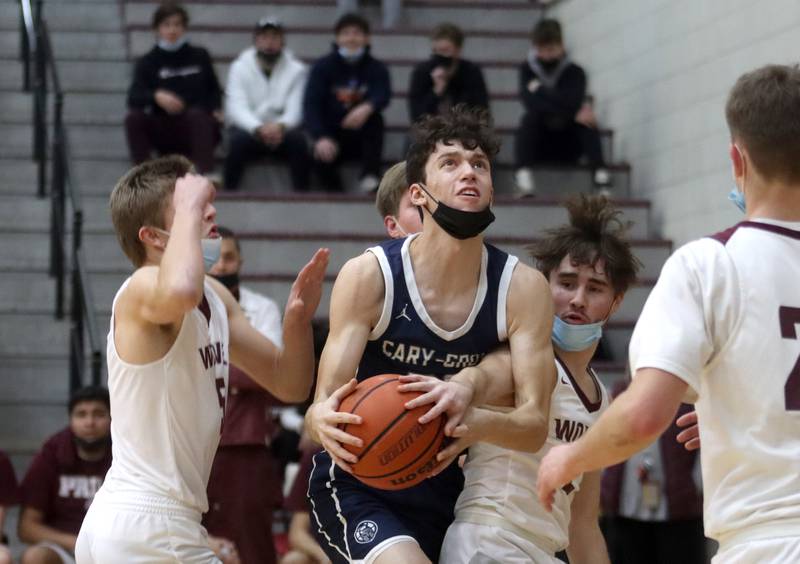 Prairie Ridge’s Mason Loucks, left, keeps pace with Cary-Grove’s Jake Hornok during boys varsity basketball action in Crystal Lake Tuesday night.