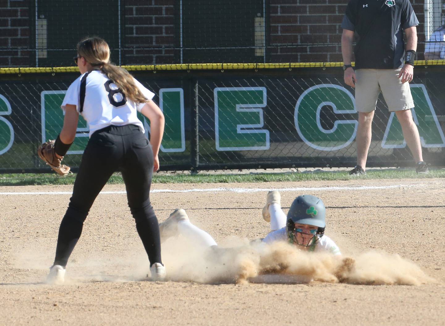 Seneca's Alyssa Zellers slides in safely to second base as Putnam County's Gabby Doyle waits for the late throw on Thursday, April 13, 2023 at Seneca High School.