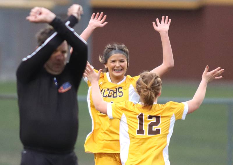 Jacobs’ Kylie Deegan, back, celebrates her goal with teammate Clare Leib (12) against Hampshire in varsity girls soccer on Thursday, April 17, 2025, at Jacobs High School in Algonquin.