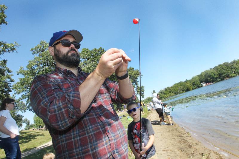 Troy Costlow, of Grayslake helps his son, Teddy, 6, get his fishing pole ready during the Family Fishing Event at Lake Front Park on Saturday, September 9th in Round Lake Beach. The event was sponsored by the Round Lake Area Park District and the Huebner Fishery Management Foundation.
Photo by Candace H. Johnson for Shaw Local News Network
