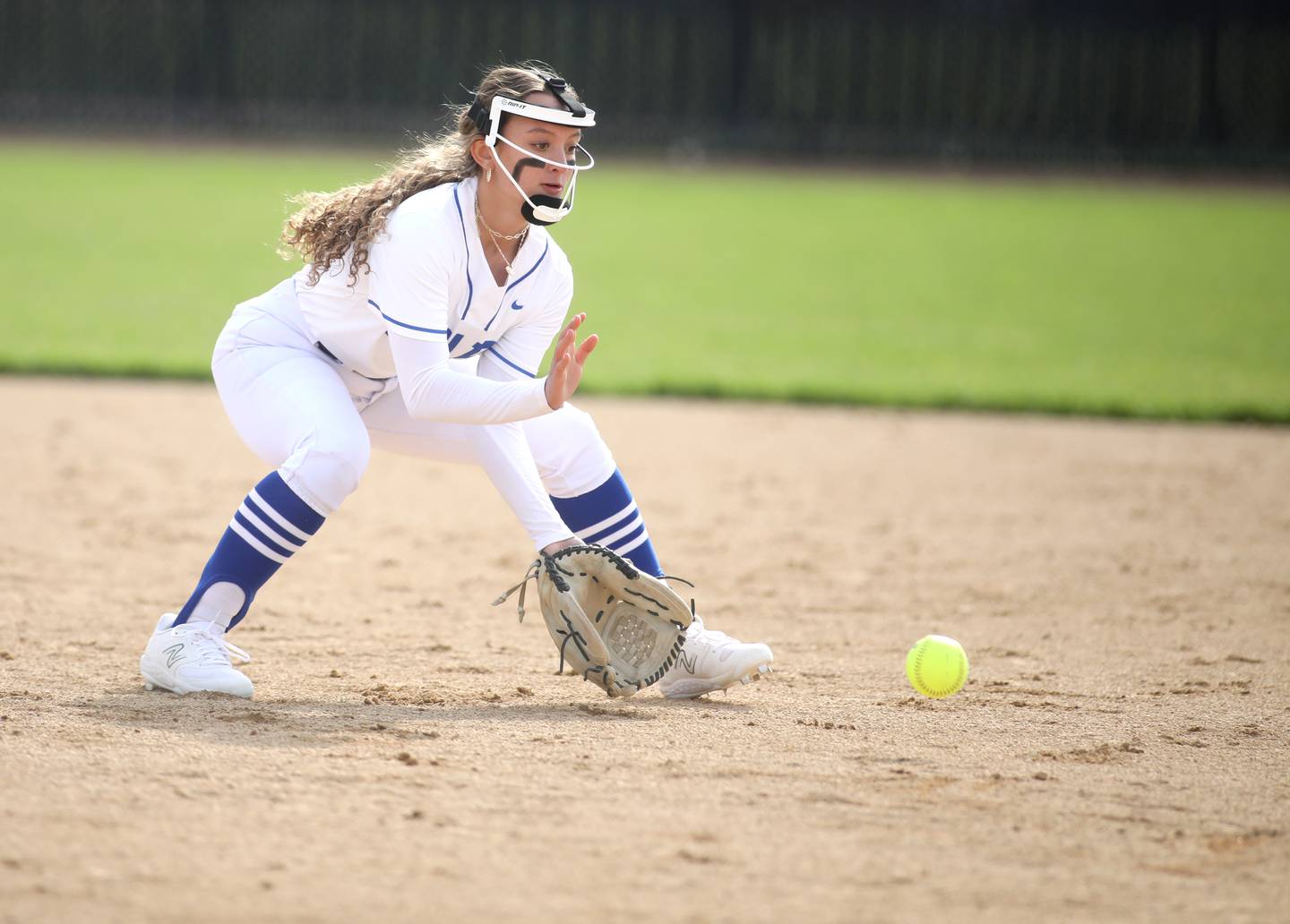 St. Charles North’s Ginger Ritter picks up a ground ball during a home game against St. Charles East on Monday, April 24. 2023.