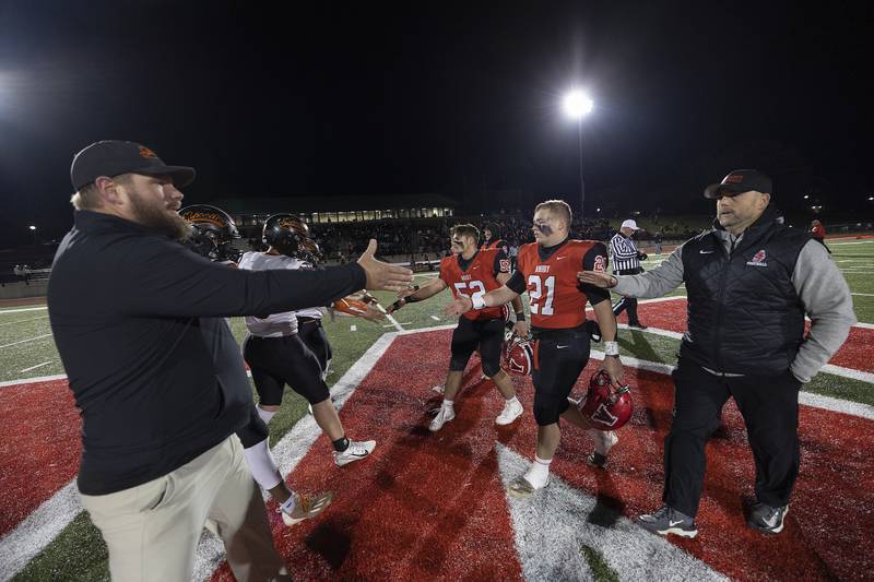 The Milledgeville Missiles (left) and Amboy Clippers shake hands Friday, Nov. 22, 2024, at the start of the 8-man football championship in Monmouth.
