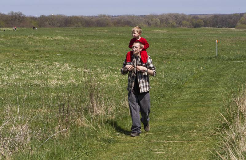 Cory Moore, of Crystal Lake, walks through the prairie with son Jackson, then 3, during the Earth Day Celebration on Saturday, April 23, 2016, at Prairieview Education Center in Crystal Lake. The event included guided nature hikes, games and crafts, puppet Shows, over 20 environmental exhibitors, as well as food & beverage vendors.