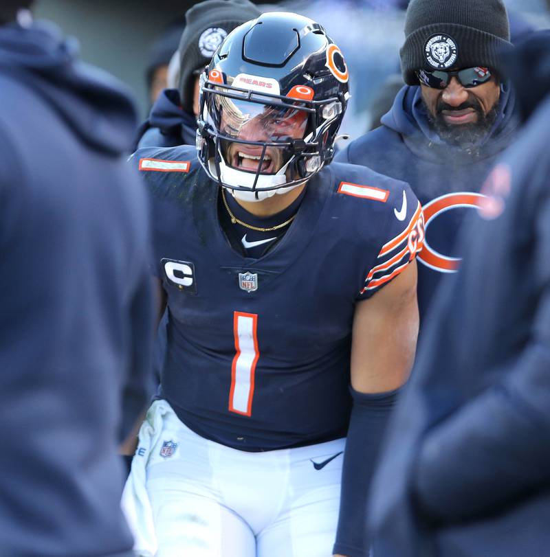Chicago Bears quarterback Justin Fields grimaces in pain after coming out of the game for a play during their game Sunday, Dec. 18, 2022, at Soldier Field in Chicago.