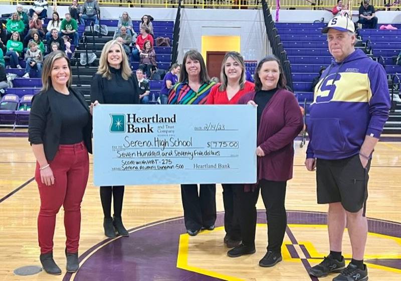 Heartland Bank and Trust Company presented a donation of $275 to Serena High School for orders placed for the school’s Spirit Debit Cards. Heartland Bank’s Spirit Debit Card program  features 54 local schools with the school’s team mascot or crest as an optional design for the face of the card.