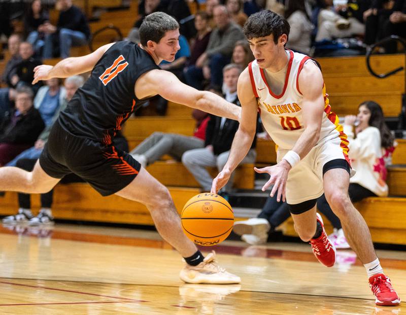 Batavia guard Joe Reid drives the lane during a home game against Wheaton Warrenville South on Tuesday, Jan. 7, 2025.