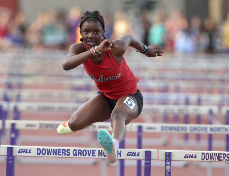Palatine’s Aisha Kazeem competes in the 100-meter hurdles during the Ritter Invite girls track and field meet at Downers Grove North on Friday, April 14, 2023.