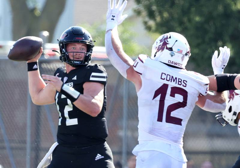 Northern Illinois' Rocky Lombardi gets off a pass just ahead of the pressure of Southern Illinois' Branson Combs during their game Saturday, Sept. 9, 2023, in Huskie Stadium at NIU in DeKalb.