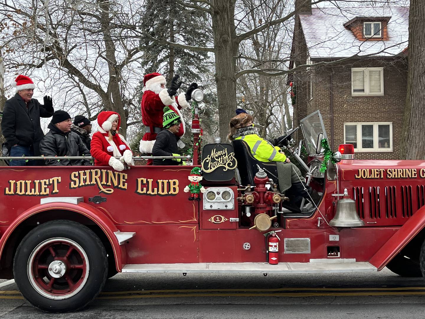 Santa Claus, along with Joliet city officials, ride through Joliet on Saturday, Dec. 17, 2022, for the Santa Send-Off parade.