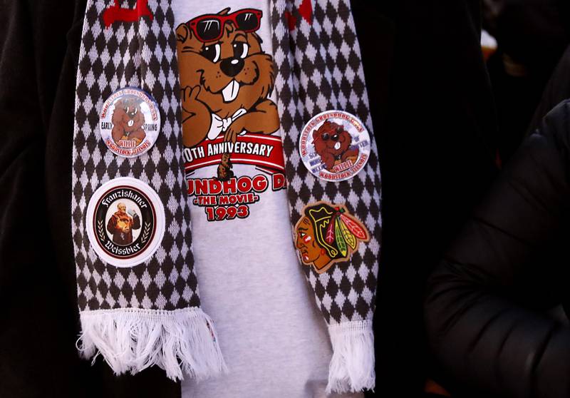 A fan sports a groundhog shirt and scarf Thursday, Feb, 2, 2023, during the annual Groundhog Day Prognostication on the Woodstock Square.