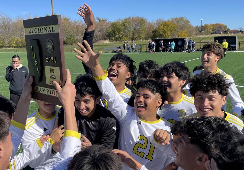 Harvard’s Hornets celebrate after a 2-1 win over Cary-Grove in IHSA Class 2A Regional Title Game soccer action on Saturday, Oct. 26, 2024, at  Harvard Junior High School  in Harvard.